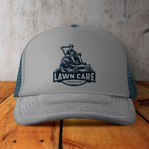 May include: A grey and blue trucker hat with a logo of a person riding a lawnmower with the text "LAWN CARE SERVICE".