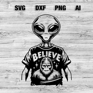 May include: Black and white illustration of an alien wearing a t-shirt with the word "Believe" and a Bigfoot graphic.