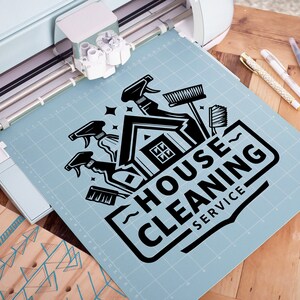 May include: A black and white graphic design of a house with cleaning supplies, including a broom, spray bottles, and a sponge. The text "HOUSE CLEANING SERVICE" is written in a bold, stylized font.