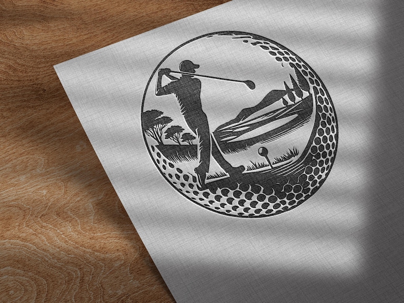 May include: Monochrome golf-themed illustration. A golfer in action is framed within a golf ball design. The background features trees, hills, and a golf tee. The design is set against a textured, light grey background.