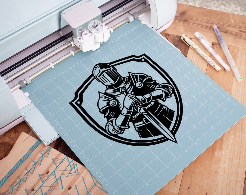 May include: A black and white illustration of a knight in armour holding a sword, inside a shield shape.