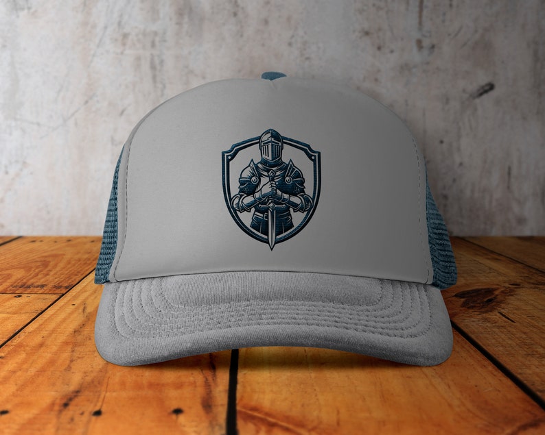May include: Grey trucker hat with a blue embroidered design of a knight holding a sword in front of a shield.