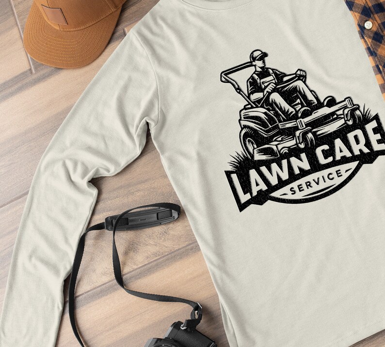 May include: A white long-sleeved t-shirt featuring a black and white illustration of a lawnmower and the text "LAWN CARE SERVICE".