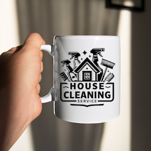 May include: White ceramic mug with a black and white graphic of a house with cleaning supplies, the text "HOUSE CLEANING SERVICE" is below the graphic.