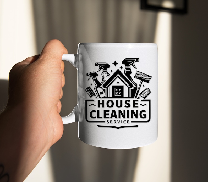 May include: White ceramic mug with a black and white graphic of a house with cleaning supplies, the text "HOUSE CLEANING SERVICE" is below the graphic.