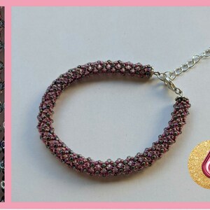 May include: A pink and silver beaded bracelet with a silver clasp and chain. The bracelet is made with small, iridescent beads.