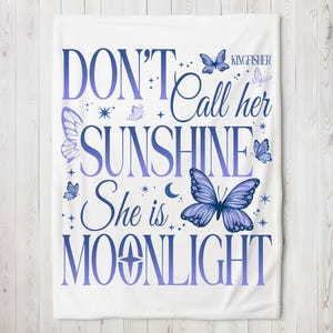 May include: White throw blanket with a purple and blue gradient design. The text "Don't Call Her Sunshine She is Moonlight" is printed on the blanket with a butterfly and stars design.