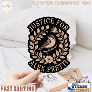 May include: A black sticker with the text "JUSTICE FOR ALEX PRETTI" encircling a bird illustration. The sticker has a floral design in beige and is held by a hand. The text "FAST SHIPPING" is also visible.