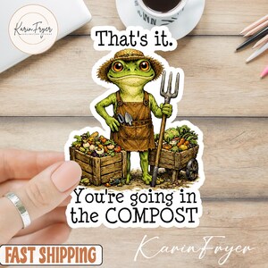 May include: A sticker featuring a cartoon frog wearing a straw hat and apron, holding a pitchfork. The frog stands between two wooden crates filled with vegetables. Text reads "That's it. You're going in the COMPOST."