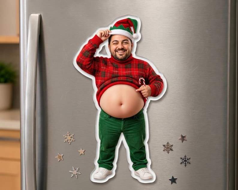May include: A die-cut refrigerator magnet featuring a smiling person wearing a red and green plaid sweater, green pants, and a festive elf hat. The person is lifting their sweater to expose their bare stomach while holding a candy cane.
