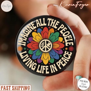 May include: A white ceramic mug with a black handle and the text "But First, Coffee" in a bold, black font. The mug is sitting on a wooden surface. The mug is approximately 4 inches tall.