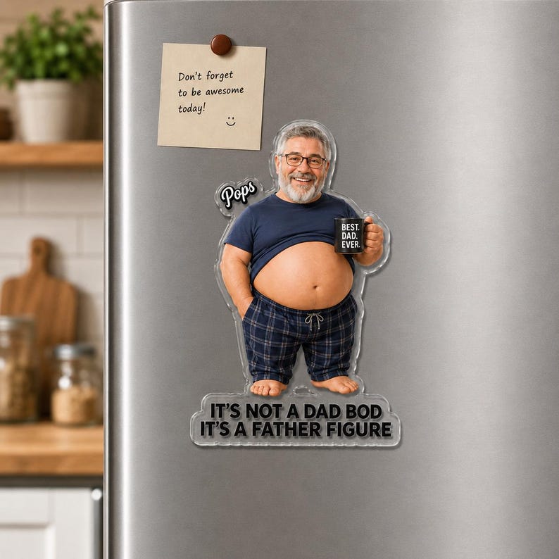 May include: A custom acrylic magnet featuring a caricature of a man with a beard and glasses, wearing a blue t-shirt and plaid pajama pants. The figure holds a mug labeled BEST. DAD. EVER. and includes the text Pops and IT'S NOT A DAD BOD IT'S A FATHER FIGURE.