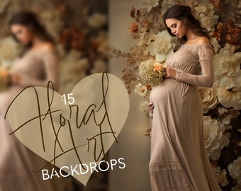 May include: A pregnant woman in a beige dress stands in front of a floral backdrop. The backdrop features large white flowers and brown leaves. The woman is holding a bouquet of white flowers with a single orange flower in the centre. The text "15 Floral Art Backdrops" is visible in the image.