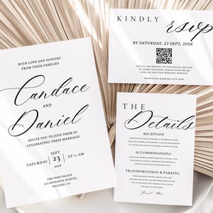 May include: Elegant wedding invitation suite featuring the names "Candace and Daniel" in a flowing script. The set includes an invitation, RSVP card, and details card, all in black text on white paper. The cards are arranged on a white plate with a neutral background.
