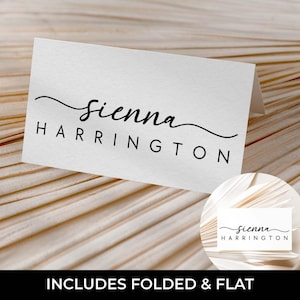 May include: A white place card with the name "Sienna Harrington" in black script and sans-serif font. The card is folded and includes a smaller, circular version of the card. The text "INCLUDES FOLDED & FLAT" is at the bottom.
