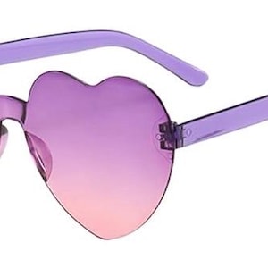 May include: Heart-shaped sunglasses featuring rimless lenses with a gradient transition from a deep purple at the top to a soft pink at the bottom. The frames include translucent purple plastic temples and a matching bridge connecting the two lenses.