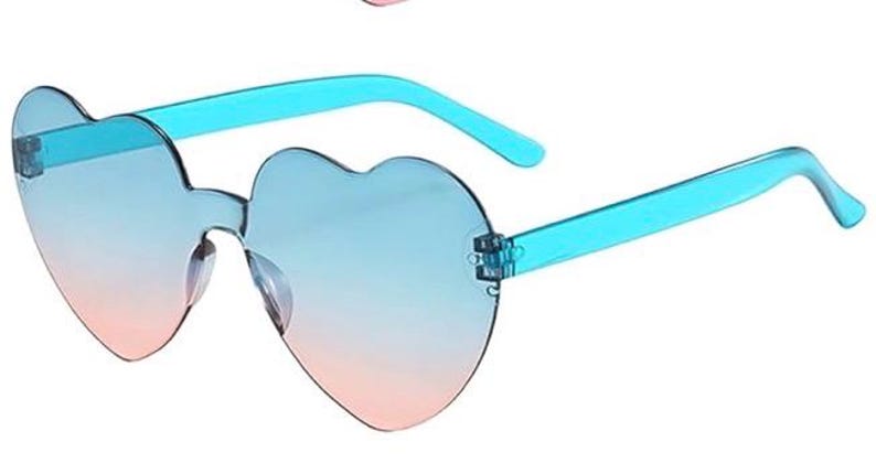 May include: Heart-shaped rimless sunglasses featuring a gradient lens that transitions from a light blue at the top to a soft pink at the bottom. The temples are made of a translucent bright blue plastic material, connecting to the lenses.