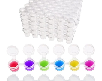 May include: A set of 100 clear plastic paint pots with lids. The pots are arranged in a grid pattern and are filled with colorful paint. The paint colors are red, purple, green, blue, yellow, and pink.