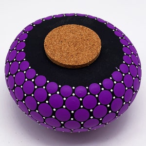 May include: Purple and white polka dot ceramic jar with a cork lid.