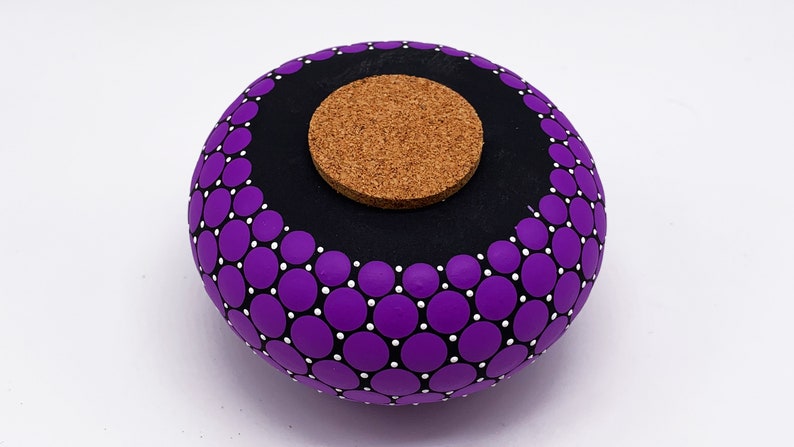 May include: Purple and white polka dot ceramic jar with a cork lid.