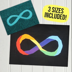 May include: A black fabric with a rainbow infinity symbol. The infinity symbol is made of fabric pieces in different colours of the rainbow. The image includes the text "3 SIZES INCLUDED!"