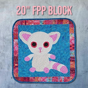 May include: A 20 inch square quilt block featuring a white, pink, and blue cartoon animal with large eyes. The block is surrounded by a colorful patchwork border.
