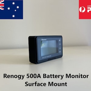 May include: A black Renogy 500A Battery Monitor with a digital display and buttons. The monitor is mounted on a white surface. The text "BATTERY MONITOR" is visible on the device.