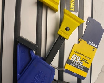 May include: A blue Irwin Quick-Grip clamp with a black handle and a yellow Irwin and DeWalt brand name on the clamp. The clamp is on a silver and black surface with a yellow label that reads "Light-Duty/Légère 63kg 140lbs Clamping Force Force de Serrage 7548EL7 150mm 6" "