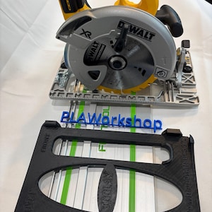 May include: A DeWalt circular saw with a yellow and black handle and a silver blade. A black guide with the text "PLAWorkshop" and "FIMIMIT" is in front of the saw. The saw is designed for construction and woodworking projects.