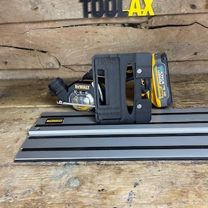 May include: A selection of black and yellow power tool accessories, including a battery and a guide rail, are shown. The text "PLAworkshop TOOLAX" is visible in the background. The front of the tool is labeled "FRONT".
