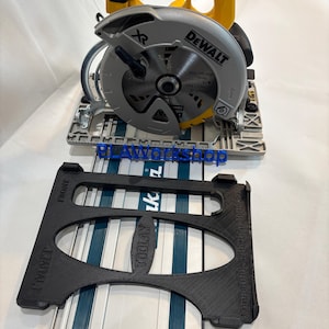 May include: A yellow and black DeWalt circular saw with a silver blade and a black guide. The guide is black and has the text "TOOLAX" and "FMMT". The saw is on a white surface.