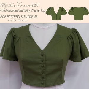 May include: Olive green fitted cropped top with butterfly sleeves and a V-neckline. The top has a button-down front and is displayed on a mannequin. Text on the image reads "Myrtle's Dream 22001 Fitted Cropped Butterfly Sleeve Top PDF PATTERN & TUTORIAL 4-20 UK / 0-16 US."