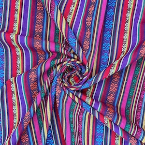 May include: Colorful striped fabric with a woven pattern. The fabric is folded and twisted, creating a swirling effect. The colors include red, purple, blue, green, yellow, and orange.