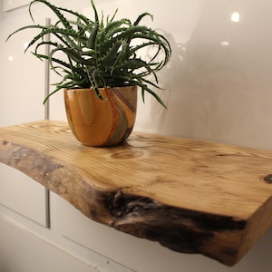 Shelf with natural edges made of reclaimed wood -