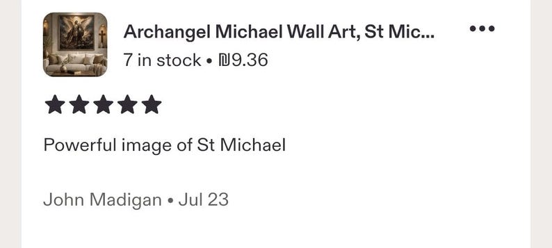 May include: A digital product listing for Archangel Michael wall art featuring a five-star rating and a customer review titled Powerful image of St Michael by John Madigan, displayed alongside a thumbnail of the artwork above a sofa.