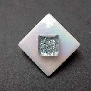 White and silver brooch