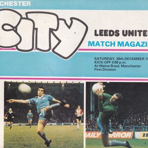 May include: Vintage match magazine cover for a Manchester City vs. Leeds United game. The cover features the word "CITY" in large letters, along with game details. The image includes action shots of the soccer game.