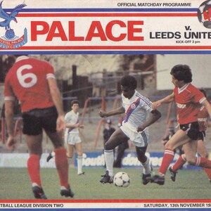 May include: A vintage football matchday program cover featuring the Crystal Palace logo and the word "PALACE" in large red letters. The cover also includes the text "LEEDS UNITED" and a football game scene with players in action. The date is Saturday, 13th November 1982.