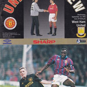 Könnte beinhalten: Ein Vintage-Fußballprogramm-Cover mit dem Titel "UNITED REVIEW" in Rot und Weiß. Das Bild zeigt Spieler beim Händeschütteln und in Aktion, Teamlogos und das Logo des Sponsors "SHARP".