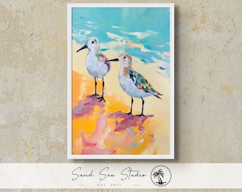 May include: A painting of two colorful sandpipers on a beach with blue water and yellow sand. The birds are facing each other and have a variety of colors, including blue, green, yellow, and pink.