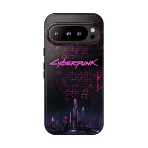 May include: A black smartphone case featuring a dark, futuristic cityscape at the bottom and a pink grid pattern above. The word Cyberpunk is printed in a stylised pink font across the centre, with a horizontal camera bar at the top.