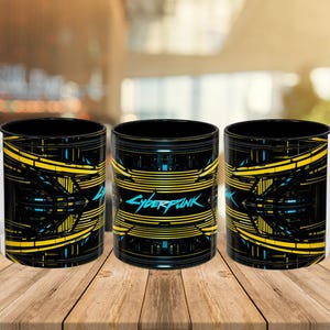 May include: Three black ceramic mugs with a yellow and blue geometric design. The mugs have the word "Cyberpunk" in teal. The mugs are on a wooden surface.