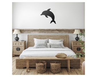 May include: A black wooden bed frame with a white duvet and pillows. Two wicker baskets are in front of the bed, and a wooden bench is in front of the baskets. A black silhouette of a dolphin is on the wall above the bed.