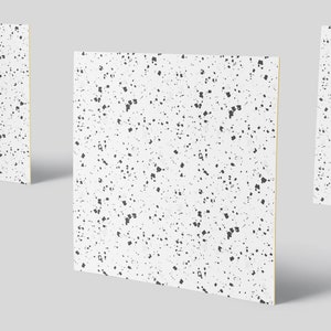 May include: Three white square tiles with a black speckled pattern. The tiles are arranged in a staggered formation.