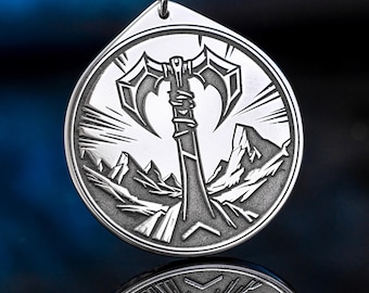 May include: Silver-toned pendant with a detailed axe design. The pendant features a double-bladed axe in front of a mountain range, with a black cord. The pendant is approximately 1.5 inches in diameter.