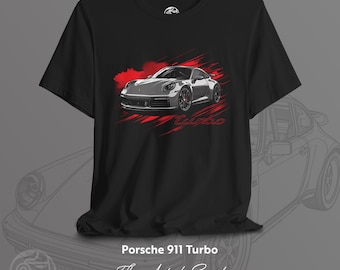 May include: Black t-shirt with a grey Porsche 911 Turbo illustration and red accents. The word "Turbo" is written in red script below the car. The shirt also has the text "Porsche 911 Turbo", "The Art of Speed", and "T-SHIRT COLLECTION".