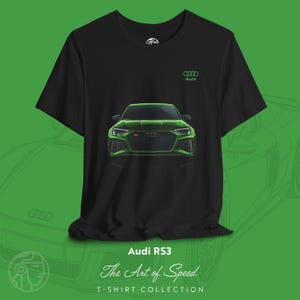 May include: Black t-shirt featuring a green illustration of an Audi RS3 car on the front. The Audi logo is on the upper right. Below the car graphic are the words "Audi RS3" and "The Art of Speed" and "T-SHIRT COLLECTION".