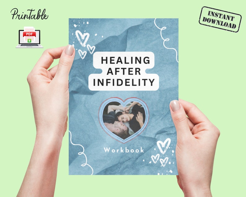 May include: A blue and white workbook with the title "Healing After Infidelity" and a photo of a couple embracing. The cover has a heart shape around the photo and white hearts scattered around the cover.