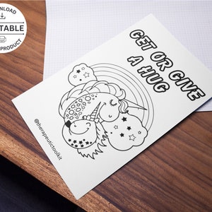 May include: Black and white coloring page featuring a unicorn and a narwhal hugging. The text "Get or Give a Hug" is at the top of the page.