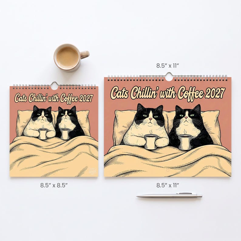 May include: Two wall calendars titled Cats Chillin' with Coffee 2027, featuring illustrations of two black and white cats in bed with mugs. One calendar is 8.5 by 8.5 inches, the other is 8.5 by 11 inches. A coffee mug and a silver pen are included.
